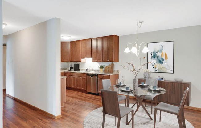 Laurel West End Apartments in Golden Valley, MN photo of a dining area with a table and chairs and a kitchen in the background