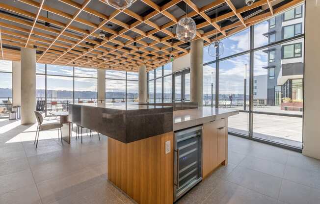 a kitchen with a large island in the middle of a room with floor to ceiling windows at Marina Square, Bremerton, Washington 98337