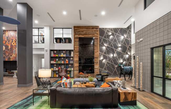 a living room with a large leather couch and a fireplace