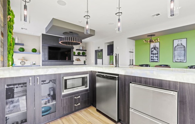 a kitchen with gray cabinets and green walls