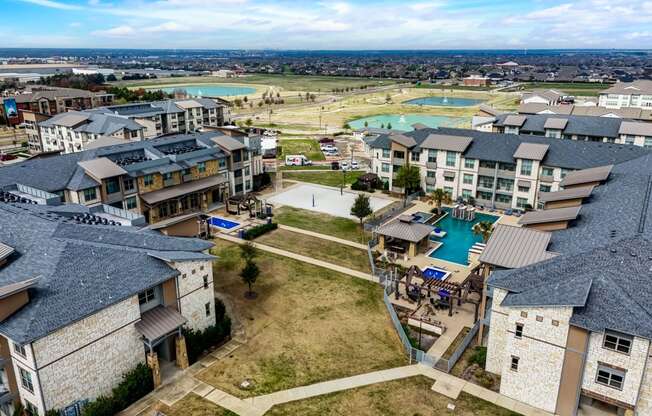 an aerial view of a community with houses and a pool