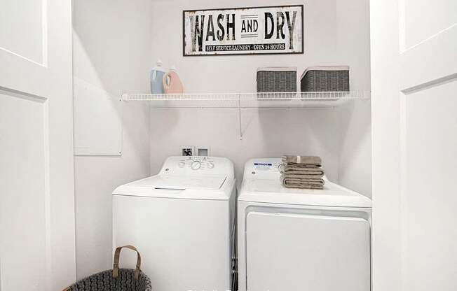 A laundry room with a full size washer and dryer at Trade Winds Apartment Homes, Elkhorn, Nebraska