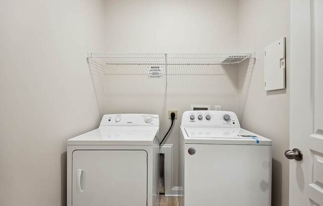 A white dryer and washer in a laundry room.