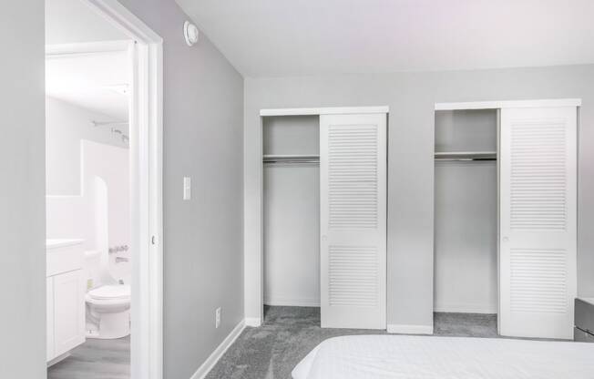 a bedroom with a bed and two closets