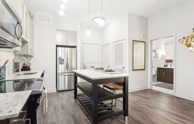 a kitchen with a large island and a refrigerator