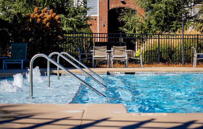 a swimming pool with a metal in front of chairs