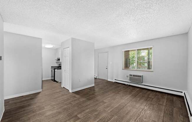 A room with wooden floors and white walls.