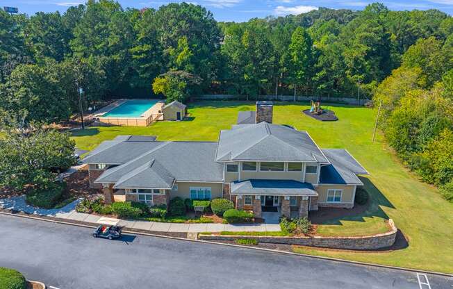 a large house with a yard and a swimming pool