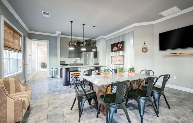 a dining room and kitchen with a large table and chairs