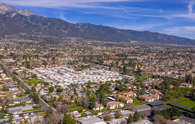 A suburban neighborhood with houses and a mountain range in the background.