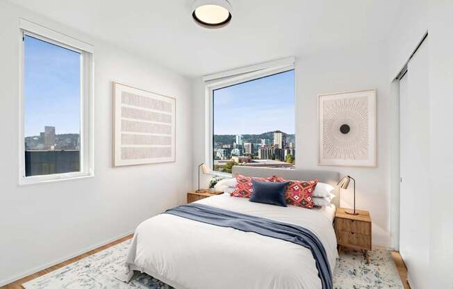 A bedroom with a large bed and a view of the city.