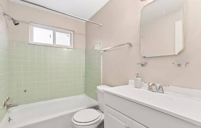 a bathroom with a sink toilet and a bath tub