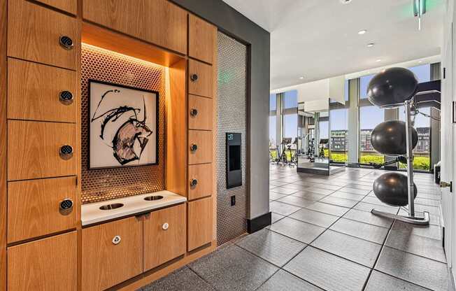 A modern kitchen with wooden cabinets and a fridge.
