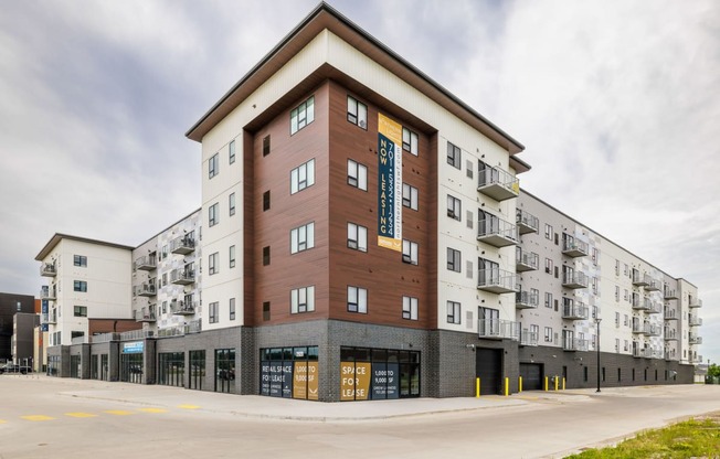 a large apartment building with a street in front of it