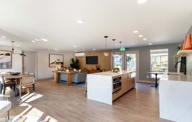 A modern kitchen with a dining table and chairs.