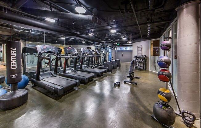 a row of exercise equipment in a gym