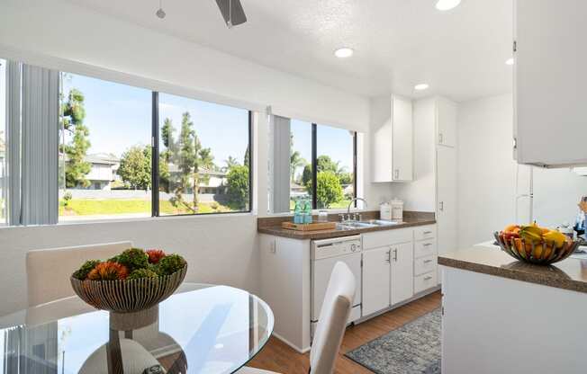 an open kitchen and dining room with a view of the yard