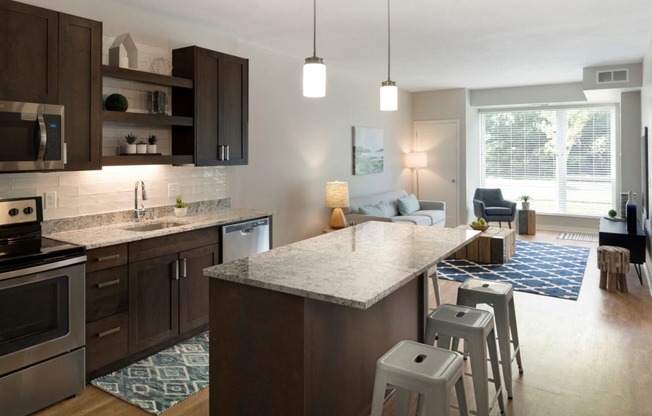 Kitchen Island Near Living Room at The McMillan Apartments in Shoreview, MN 55126