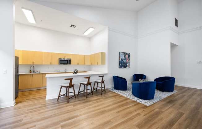 a living room with a kitchen and a table and chairs