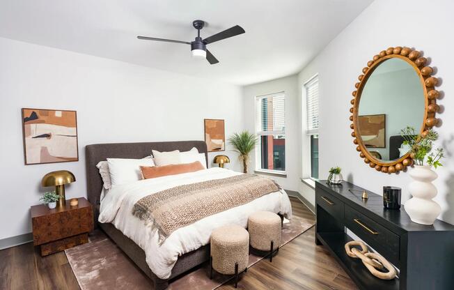 A bright and airy bedroom retreat featuring oversized windows, hardwood-style flooring, and contemporary finishes.