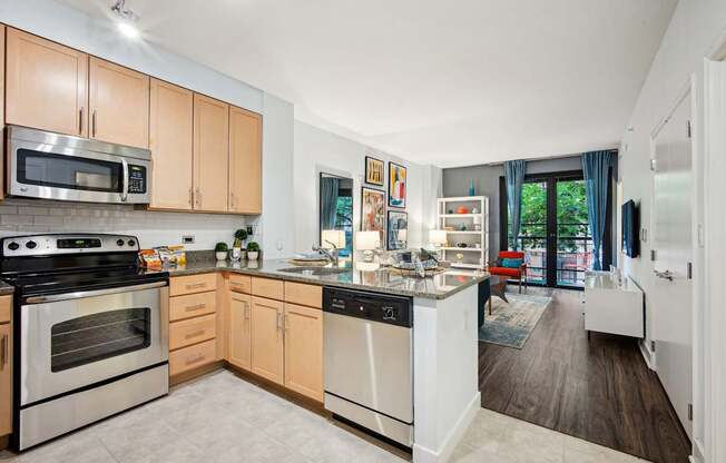 A kitchen with a black dishwasher and stove top oven.