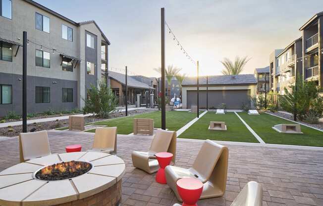 an outdoor patio with chairs and a fire pit