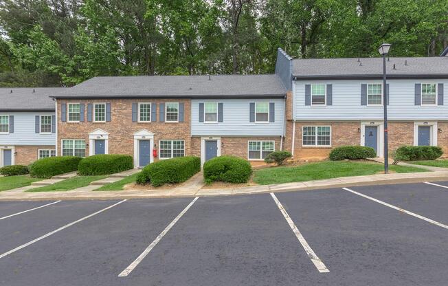 an empty parking lot in front of a house