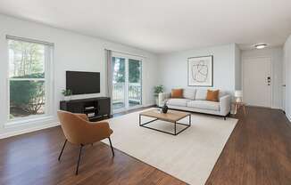 A living room with a brown chair and a white couch.