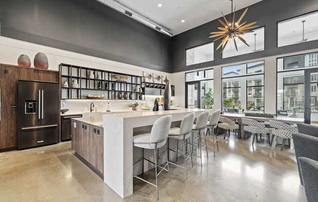 A modern kitchen with a large island and bar stools.