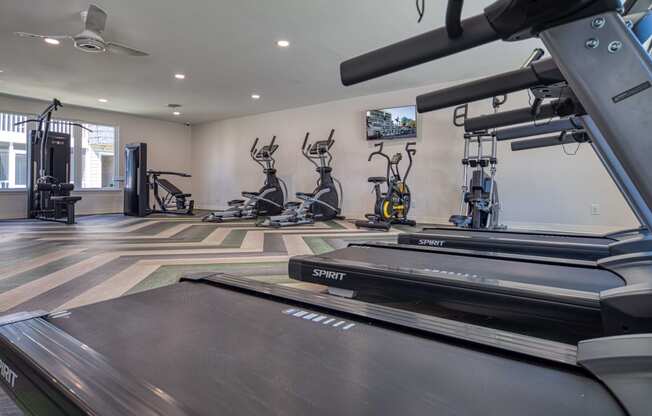 a gym with treadmills and other exercise equipment