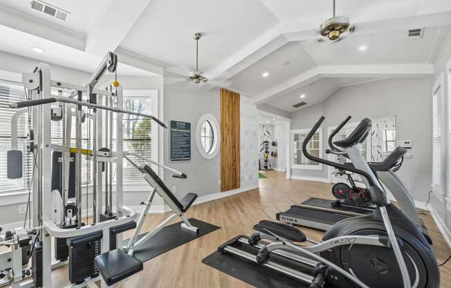 two treadmills and other exercise equipment in a home gym