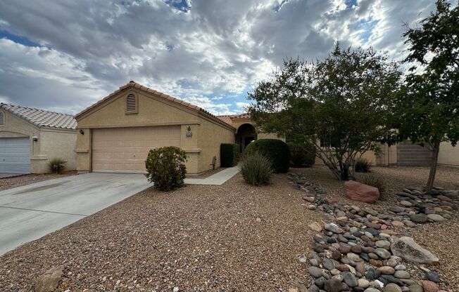 Colorful single story 4 bedroom home with tile flooring.