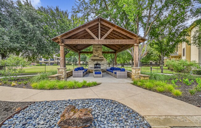 A gazebo is surrounded by a gravel area and a paved walkway. at The Canyons Apartments, Texas