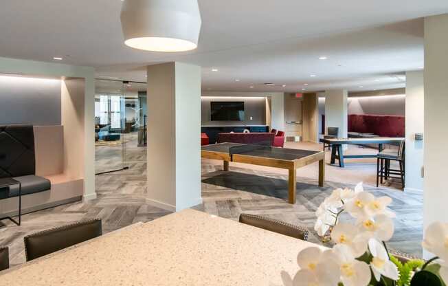 a living room and dining room with a table and chairs