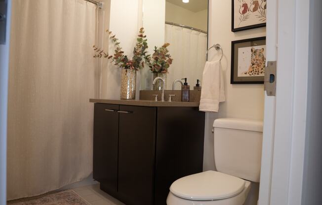 a bathroom with a toilet and a sink and a shower