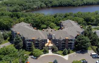 an aerial view of a large building next to a river