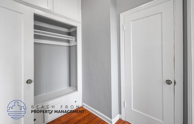 a niche in the wall of a closet with an open door