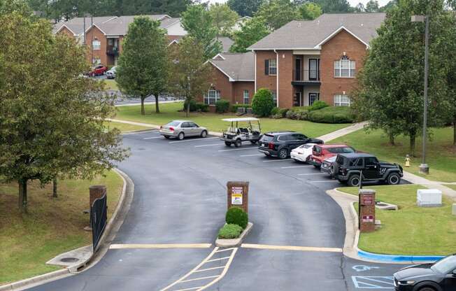 a parking lot with cars parked in front of houses