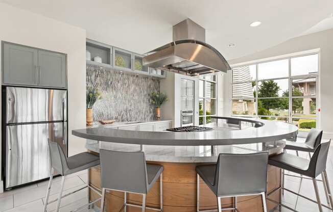 a kitchen with a large island with a breakfast bar