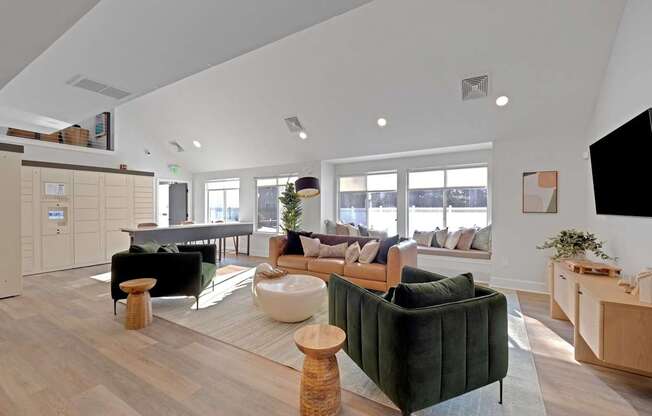 A living room with a green couch and a wooden floor.