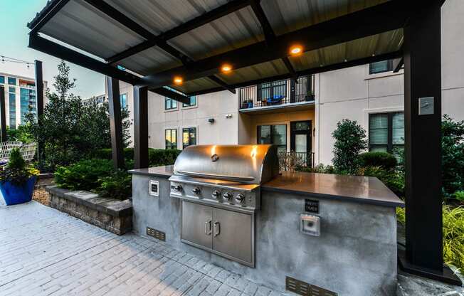 a large outdoor kitchen with stainless steel appliances and a pergola