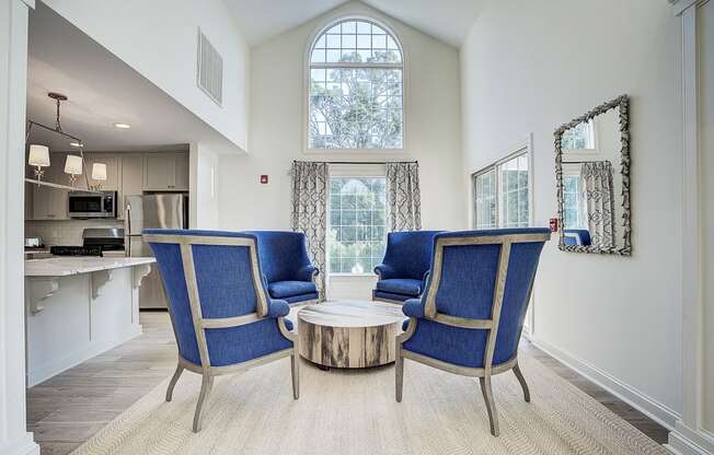 A living room with a blue chair and a coffee table.
