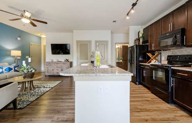 a kitchen and living room with wood floors and a ceiling fan at Alvista Round Rock, Round Rock, TX, 78664