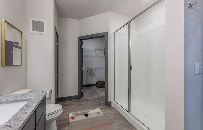 A bathroom with a toilet, sink, and shower.