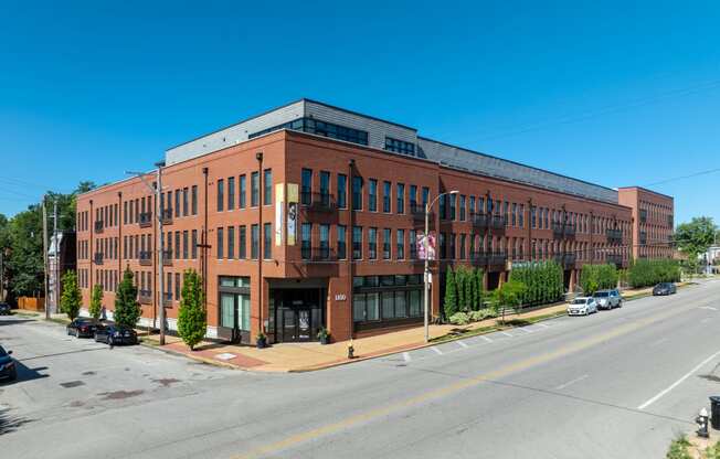 a large brick building on the corner of a street