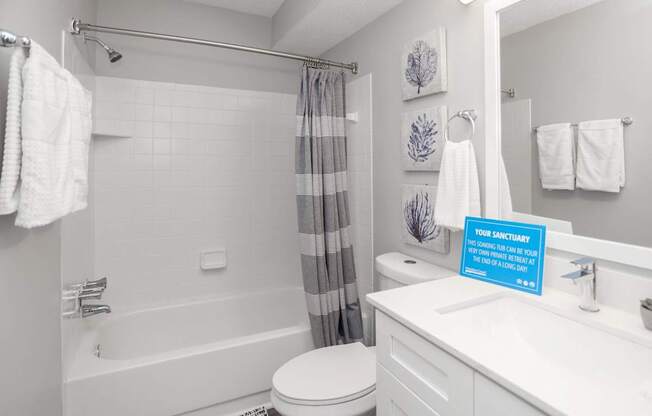 A bathroom with a towel hanging on the towel rack.
