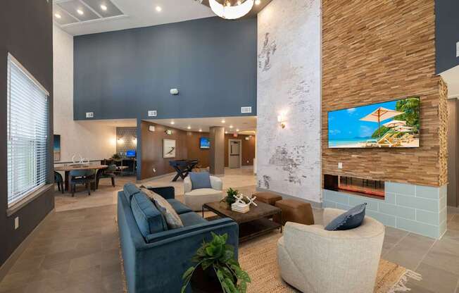 A modern living room with a blue couch and a fireplace.