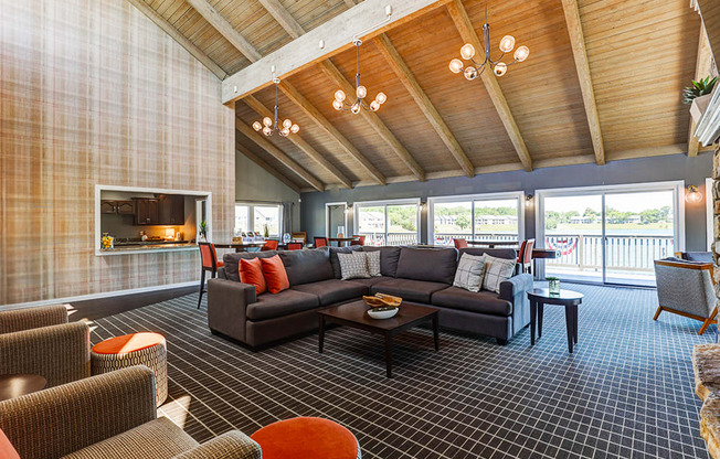Clubhouse at Somerset Lakes Apartments, featuring a large open living room with a fireplace and a balcony for relaxation.