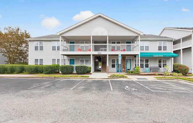 A large building with a parking lot in front.at Lofts of Wilmington, North Carolina