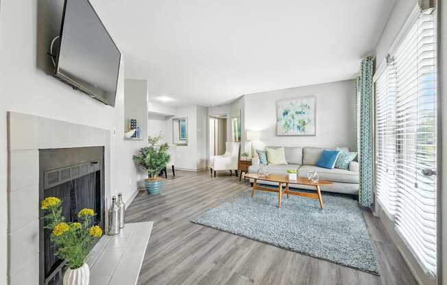A living room with a fireplace, a couch, and a television.